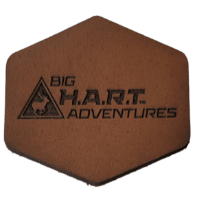 diamond-shaped, tan, leather patch with big H.A.R.T adventures logo